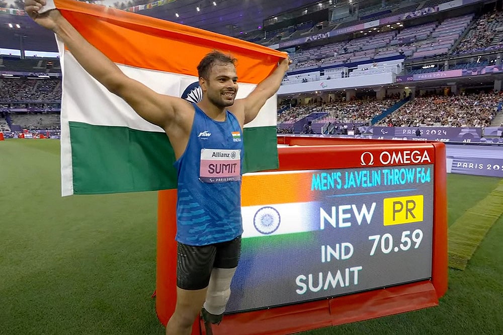 | Photo: PTI : 2024 Paris Paralympics: Sumit Antil poses for photographs after winning the gold medal in javelin throw F64 event